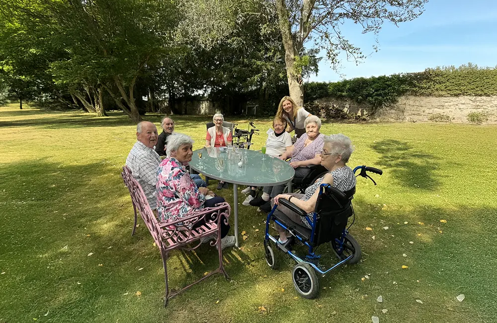 Un groupe de personne d'un certains âge dans un jardin